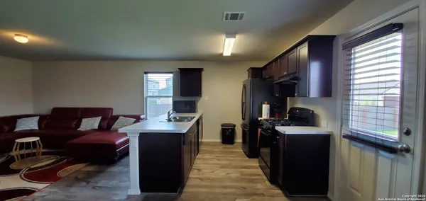 a kitchen with cabinets a sink and appliances
