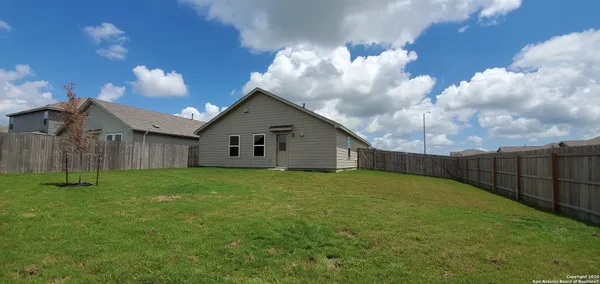 a backyard of a house with lots of green space
