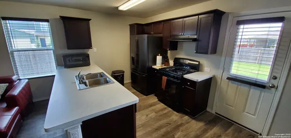 a kitchen with a refrigerator stove and a sink