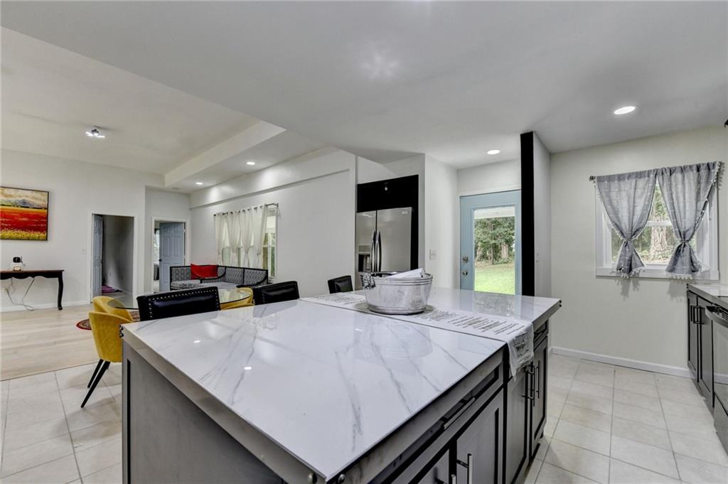 6654 Covington Road Lithonia, GA 30058 - Photo 16 of 39 a kitchen with stainless steel appliances a sink and counter space