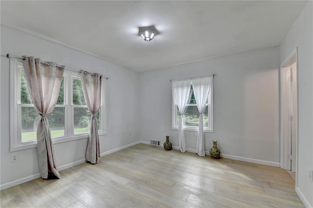 6654 Covington Road Lithonia, GA 30058 - Photo 18 of 39 an empty room with windows