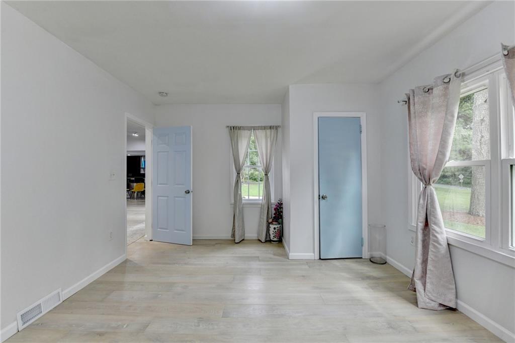 6654 Covington Road Lithonia, GA 30058 - Photo 19 of 39 an empty room with windows and closet