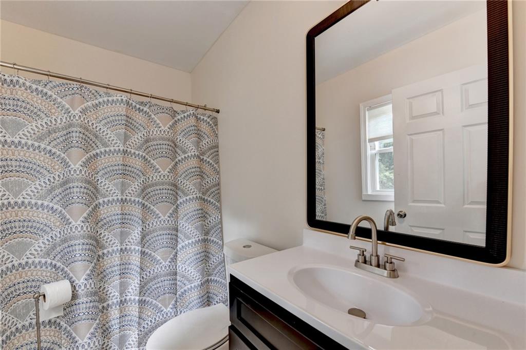 6654 Covington Road Lithonia, GA 30058 - Photo 20 of 39 a bathroom with a sink and a mirror