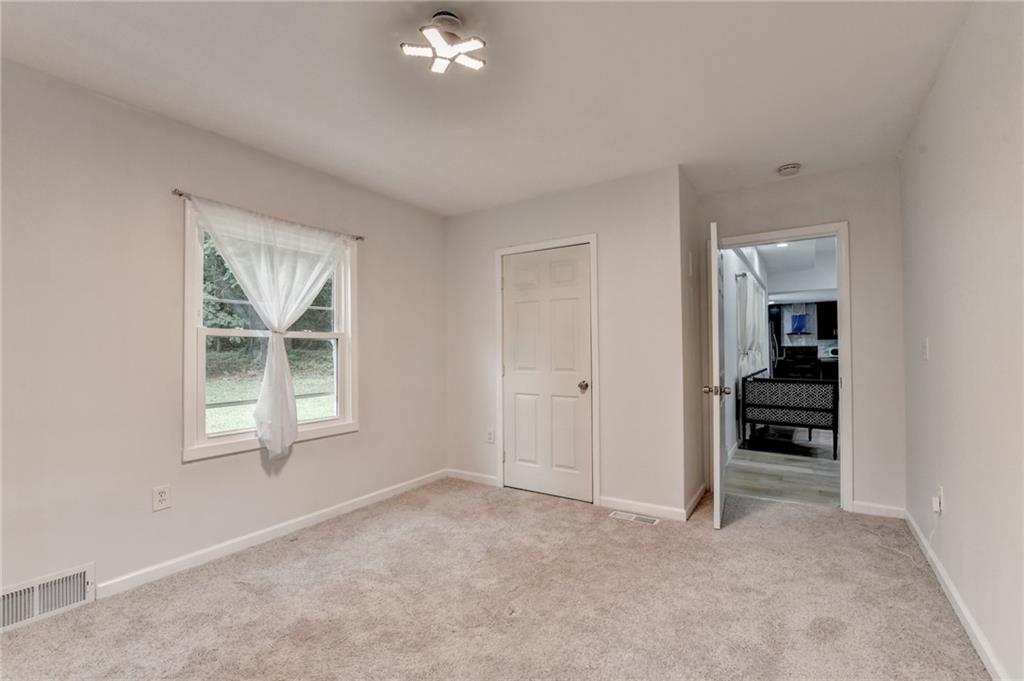 6654 Covington Road Lithonia, GA 30058 - Photo 24 of 39 a view of an empty room with a window