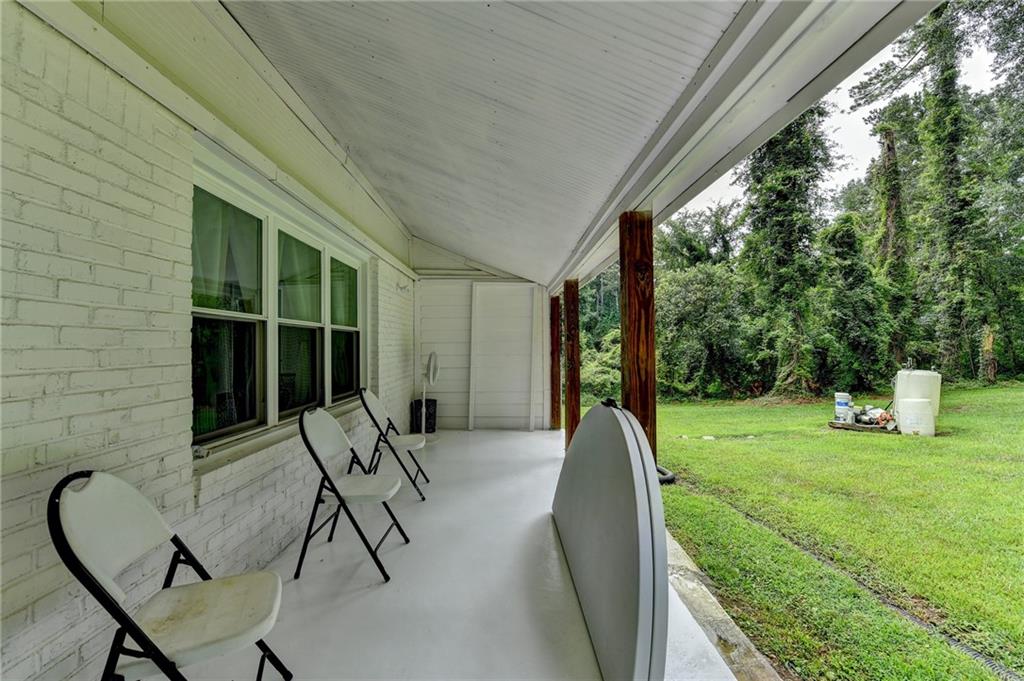 6654 Covington Road Lithonia, GA 30058 - Photo 27 of 39 a house view with a sitting space and garden