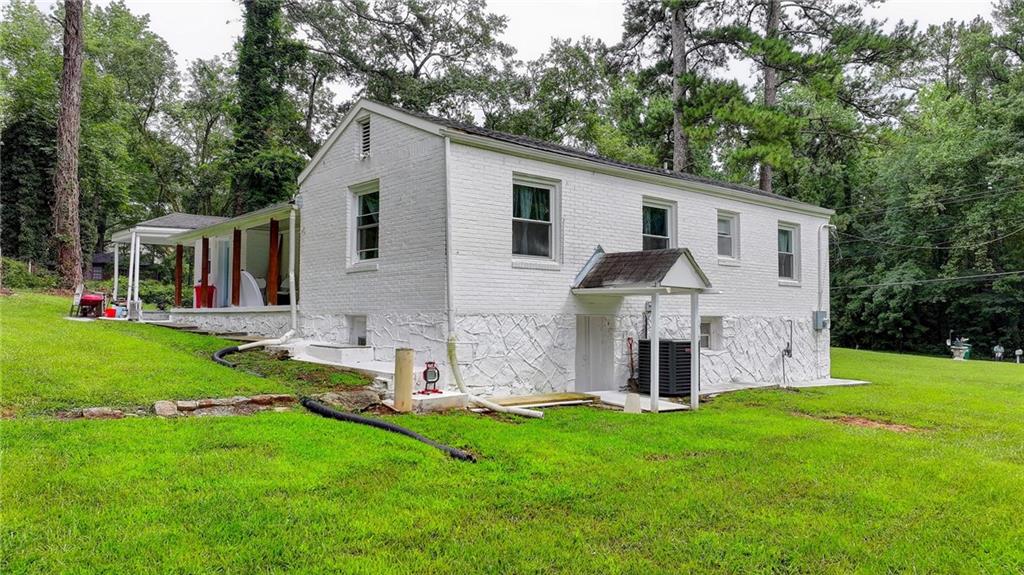 6654 Covington Road Lithonia, GA 30058 - Photo 32 of 39 a front view of house with yard and green space