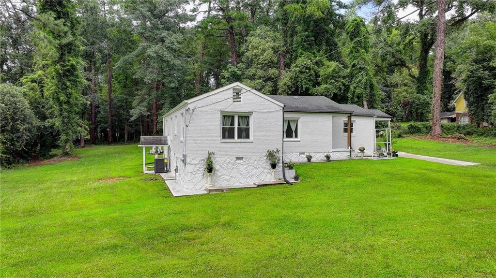 6654 Covington Road Lithonia, GA 30058 - Photo 33 of 39 a view of a house with a yard