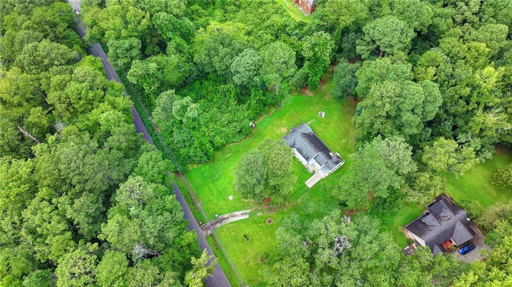 6654 Covington Road Lithonia, GA 30058 - Photo 37 of 39 an aerial view of residential house with outdoor space and trees all around
