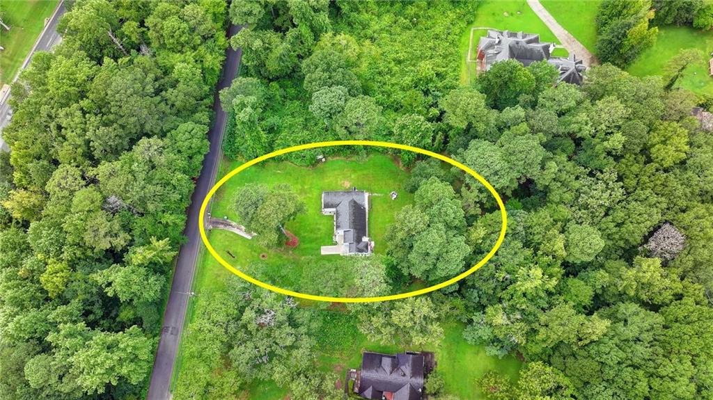 6654 Covington Road Lithonia, GA 30058 - Photo 38 of 39 an aerial view of a house with swimming pool and trees