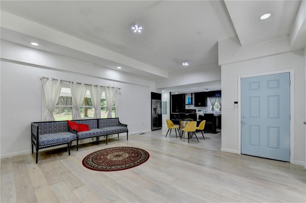 6654 Covington Road Lithonia, GA 30058 - Photo 5 of 39 a living room with furniture and a wooden floor