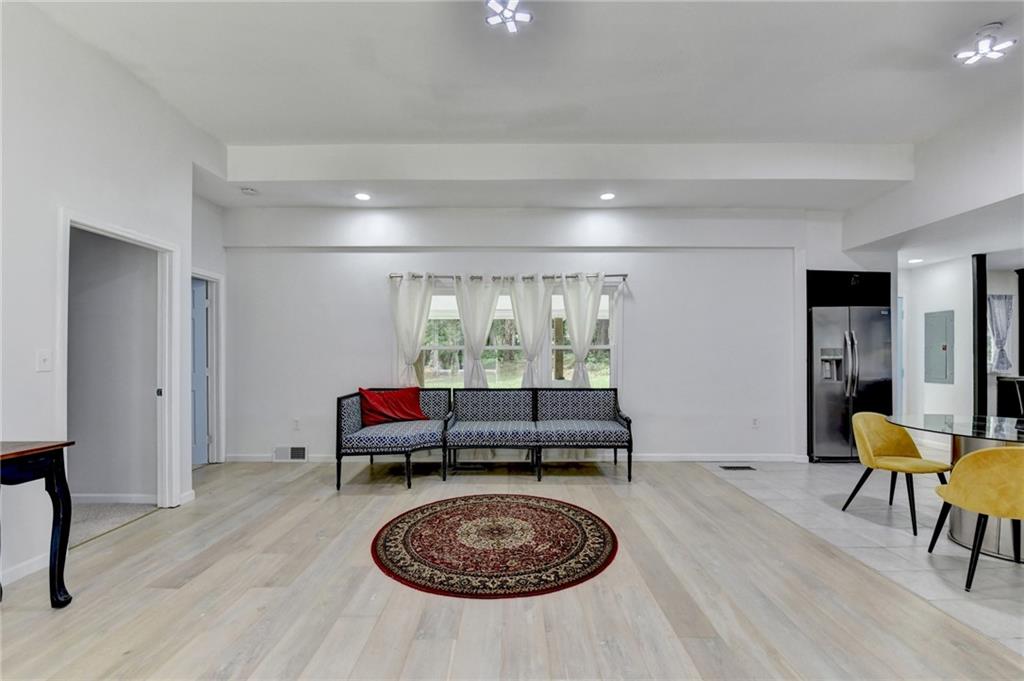 6654 Covington Road Lithonia, GA 30058 - Photo 6 of 39 a living room with furniture and a table