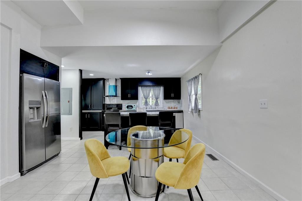 6654 Covington Road Lithonia, GA 30058 - Photo 10 of 39 a view of a dining room with furniture and a kitchen