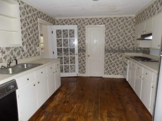 6288 Thomaston Road Macon, GA 31220 - Photo 2 of 9 a kitchen with granite countertop a sink and a stove