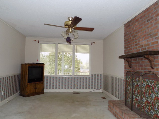 6288 Thomaston Road Macon, GA 31220 - Photo 5 of 9 a view of an empty room with a fireplace and a window