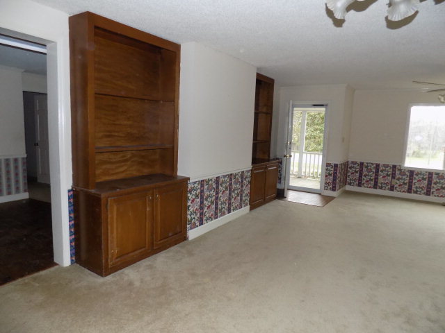 6288 Thomaston Road Macon, GA 31220 - Photo 6 of 9 a view of an empty room with window and hardwood floor