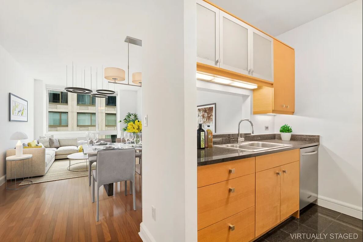 120 Riverside Boulevard, Unit 8V Manhattan, NY 10069 - Photo 3 of 9 a kitchen with granite countertop a sink dishwasher stove and cabinets with wooden floor