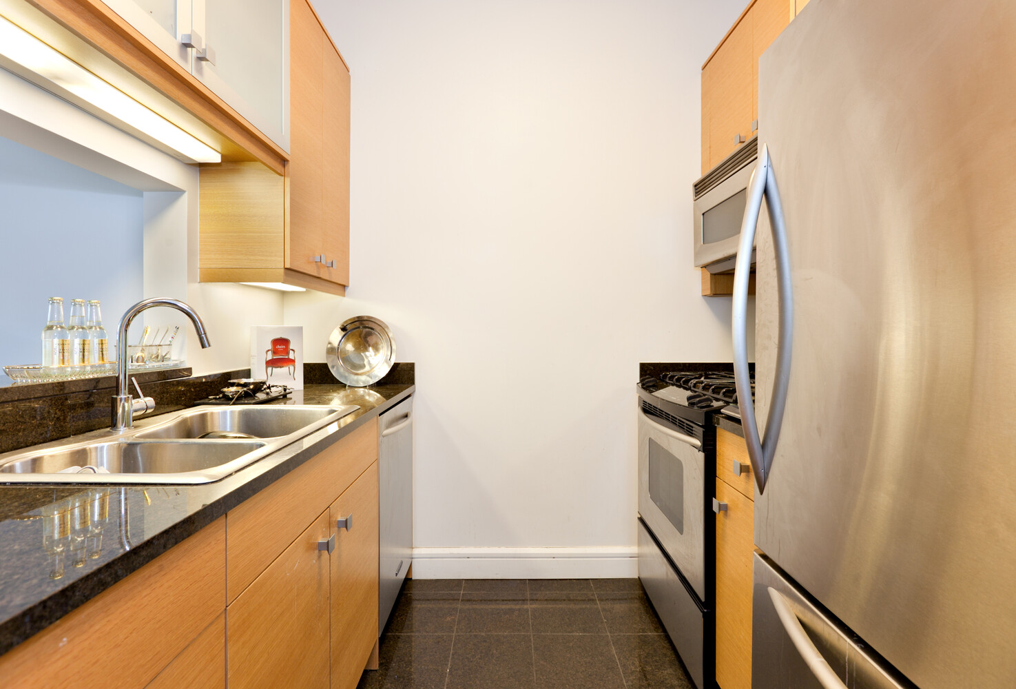 120 Riverside Boulevard, Unit 8V Manhattan, NY 10069 - Photo 4 of 9 a kitchen with a sink and a refrigerator