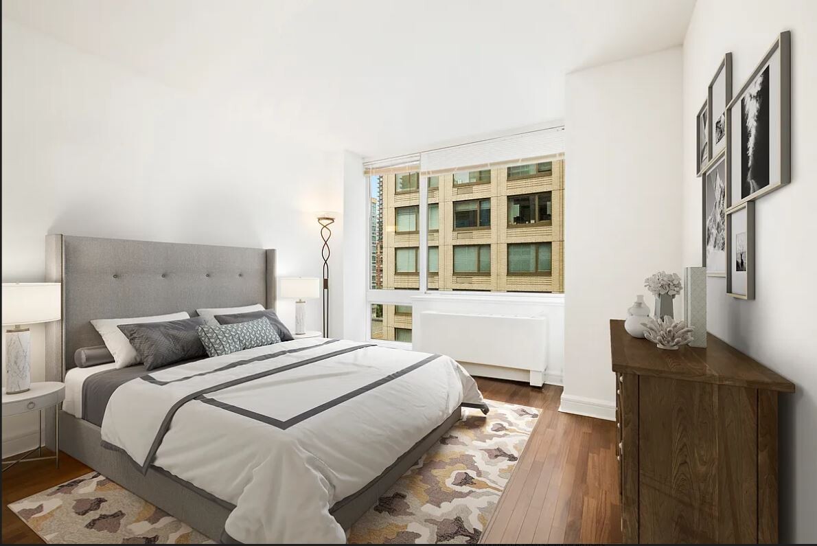 120 Riverside Boulevard, Unit 8V Manhattan, NY 10069 - Photo 5 of 9 a bedroom with a bed and wooden floor