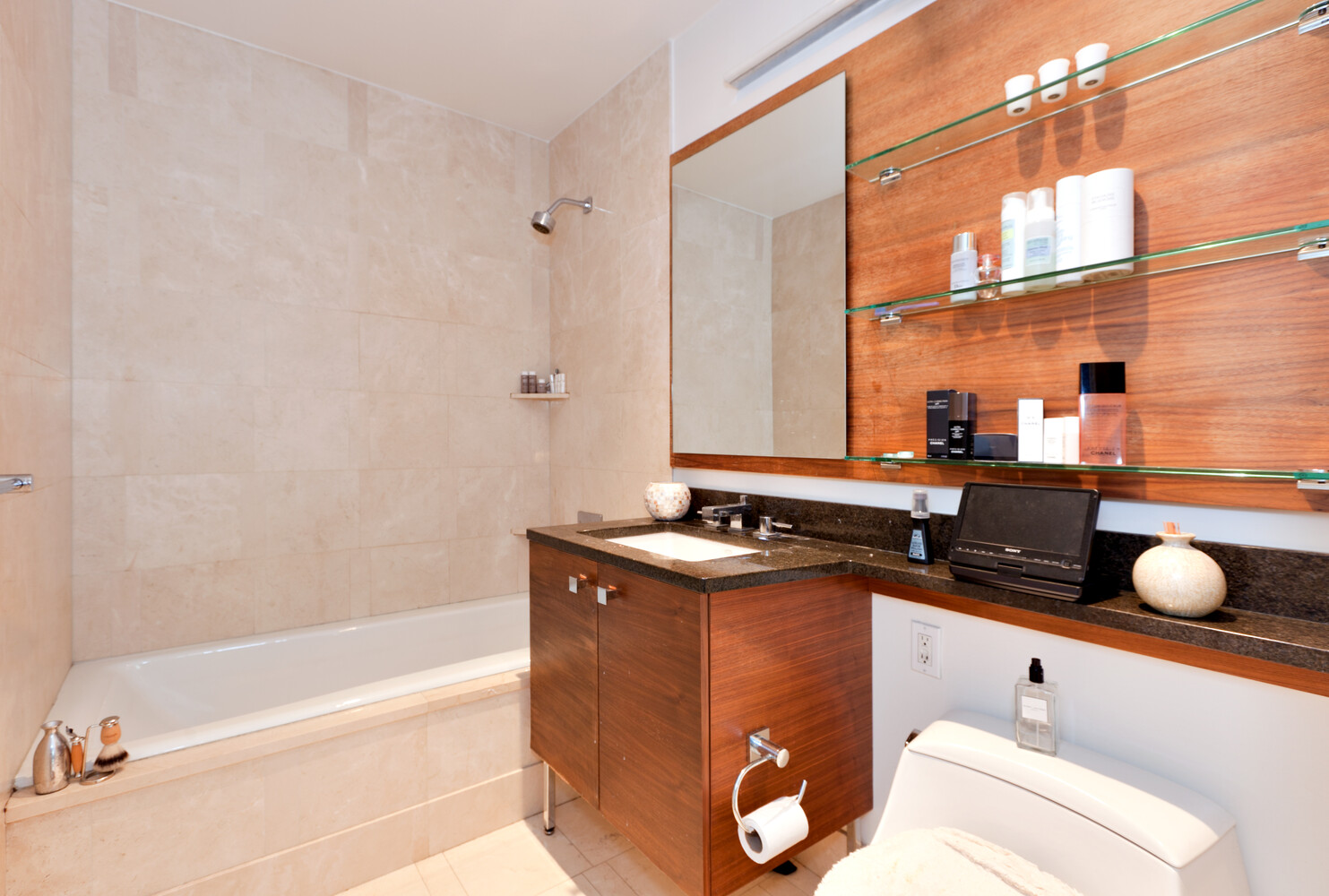 120 Riverside Boulevard, Unit 8V Manhattan, NY 10069 - Photo 6 of 9 a bathroom with a granite countertop sink a mirror and bathtub