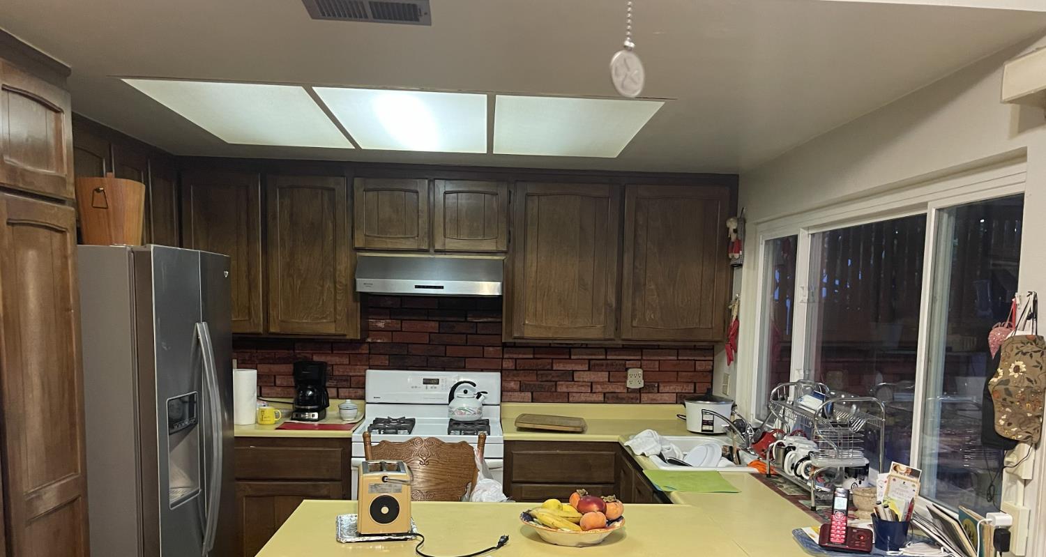 2852 Rascommon Way Sacramento, CA 95827 - Photo 3 of 6 a kitchen with a refrigerator a stove top oven a sink and dishwasher