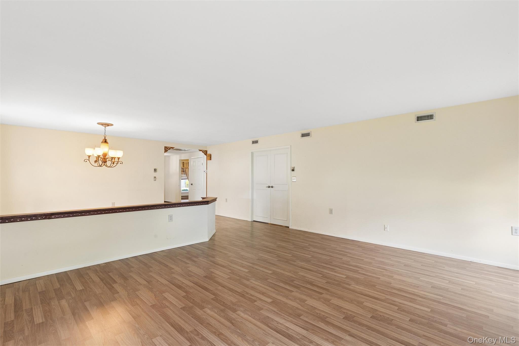 8 Coventry Court Ridge, NY 11961 - Photo 11 of 21 a view of empty room with wooden floor