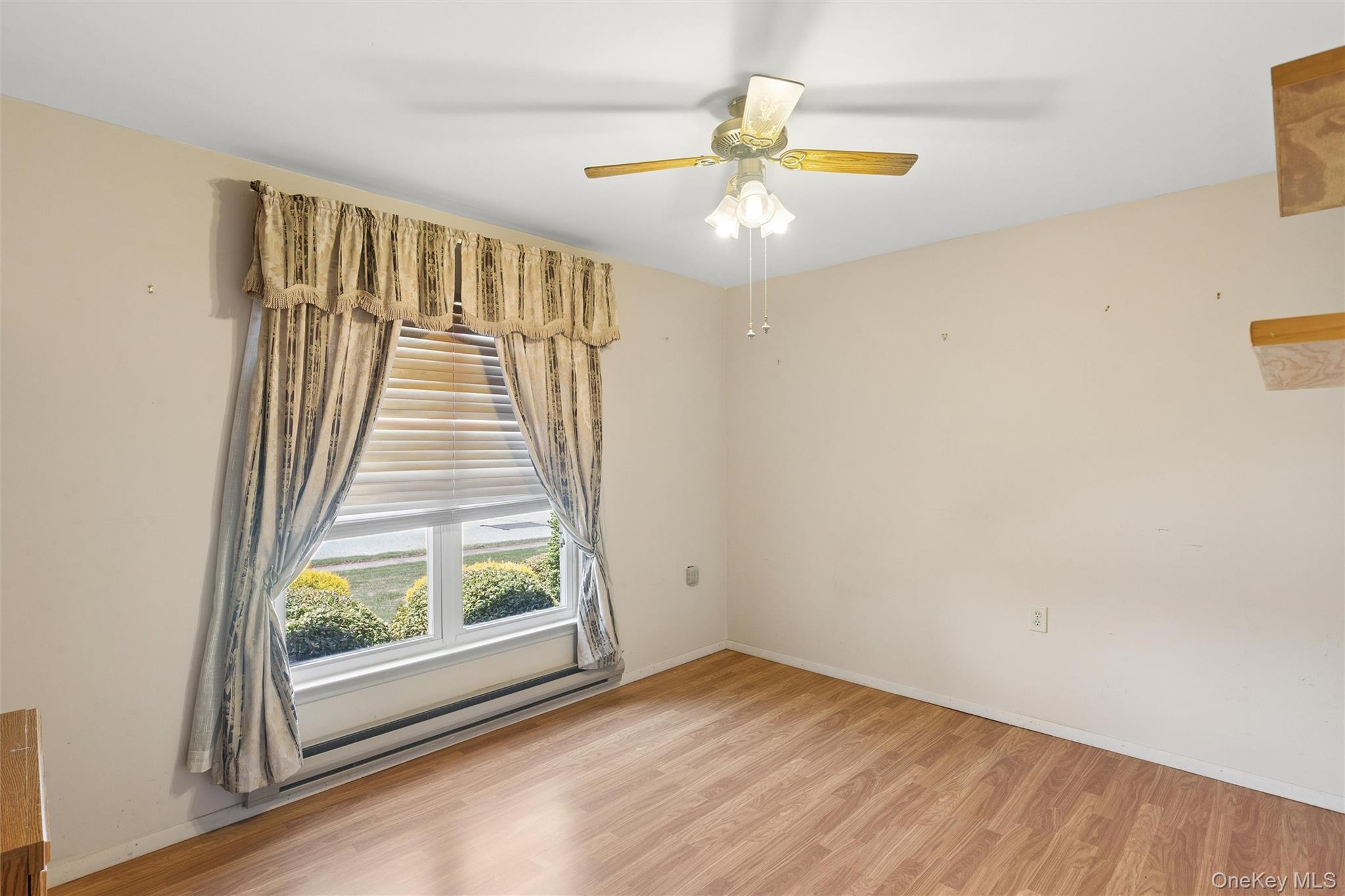 8 Coventry Court Ridge, NY 11961 - Photo 13 of 21 a view of an empty room with wooden floor and a window