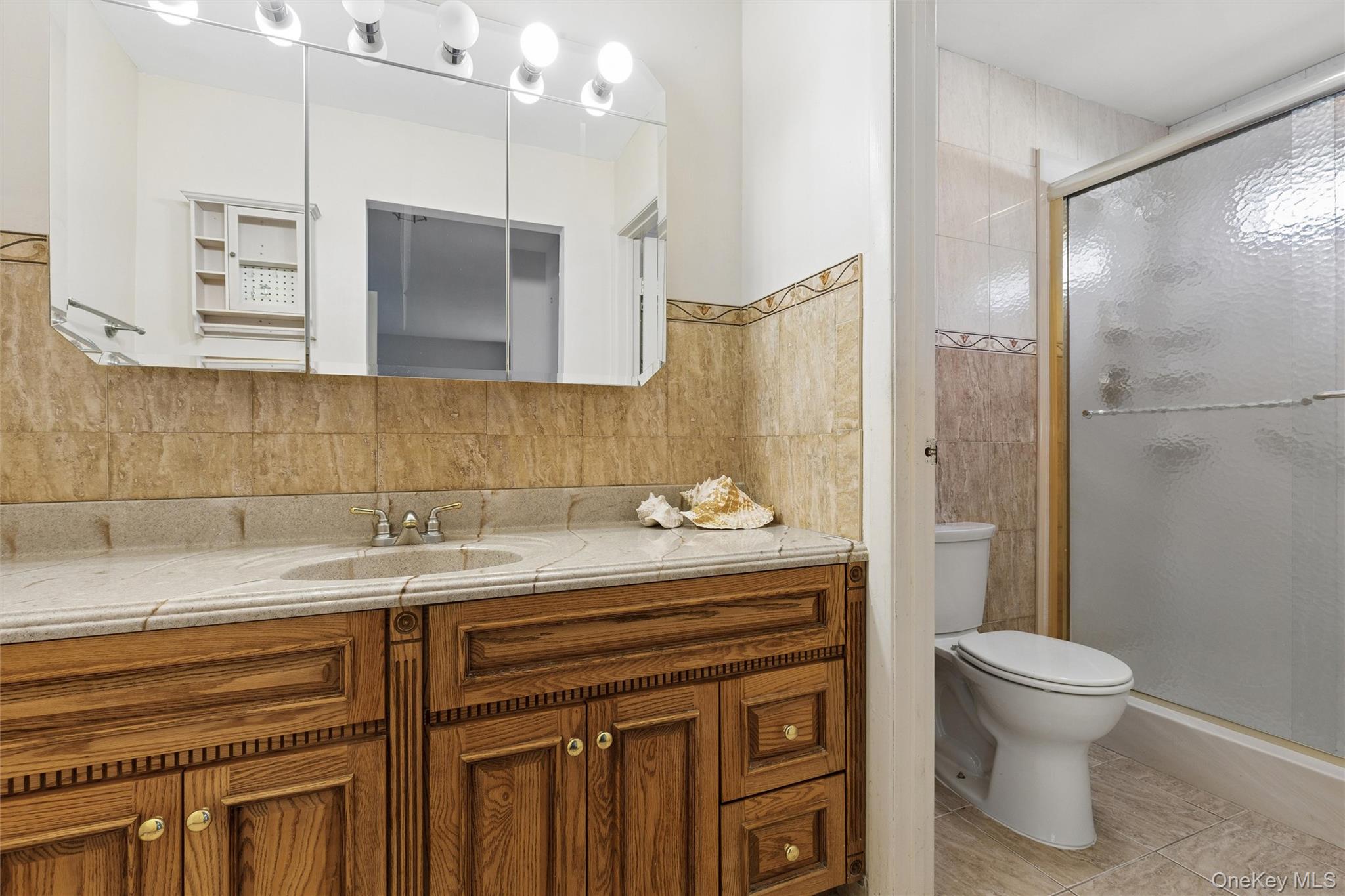 8 Coventry Court Ridge, NY 11961 - Photo 14 of 21 a bathroom with a sink toilet a mirror and shower