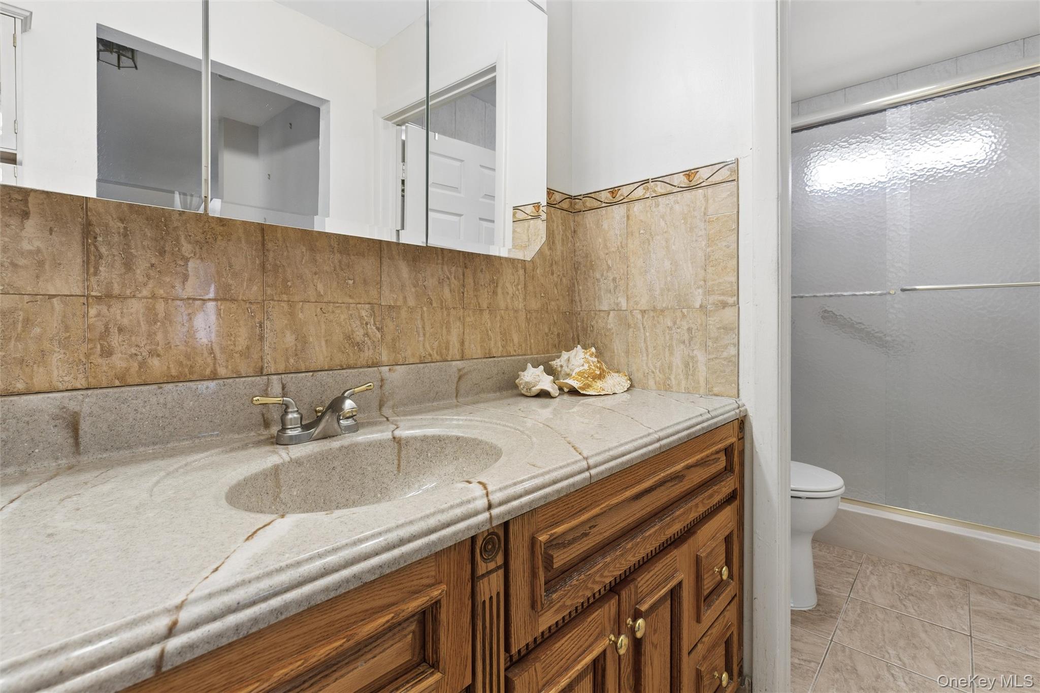 8 Coventry Court Ridge, NY 11961 - Photo 15 of 21 a bathroom with a sink and a mirror