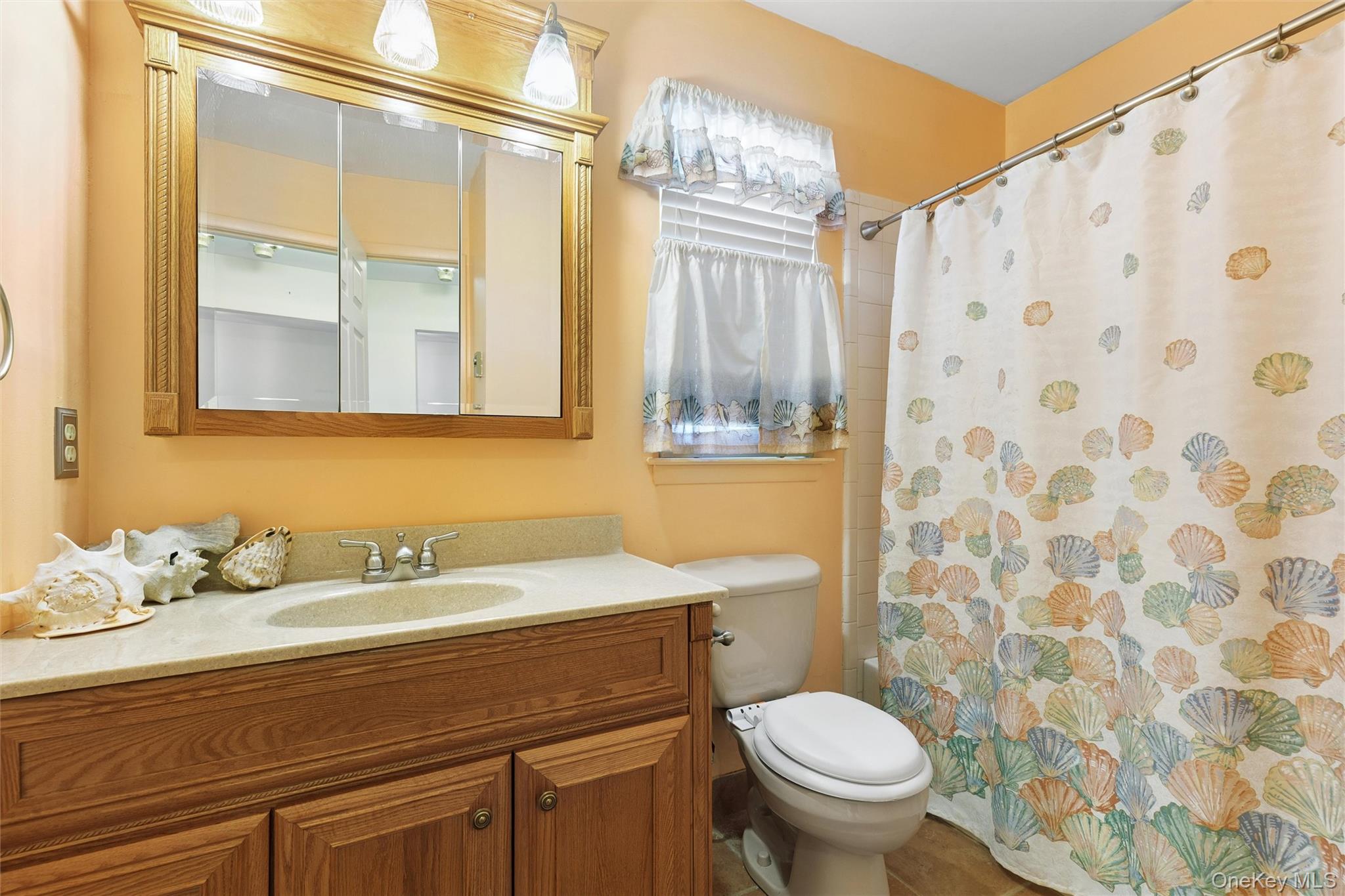 8 Coventry Court Ridge, NY 11961 - Photo 16 of 21 a bathroom with a sink a toilet and a mirror