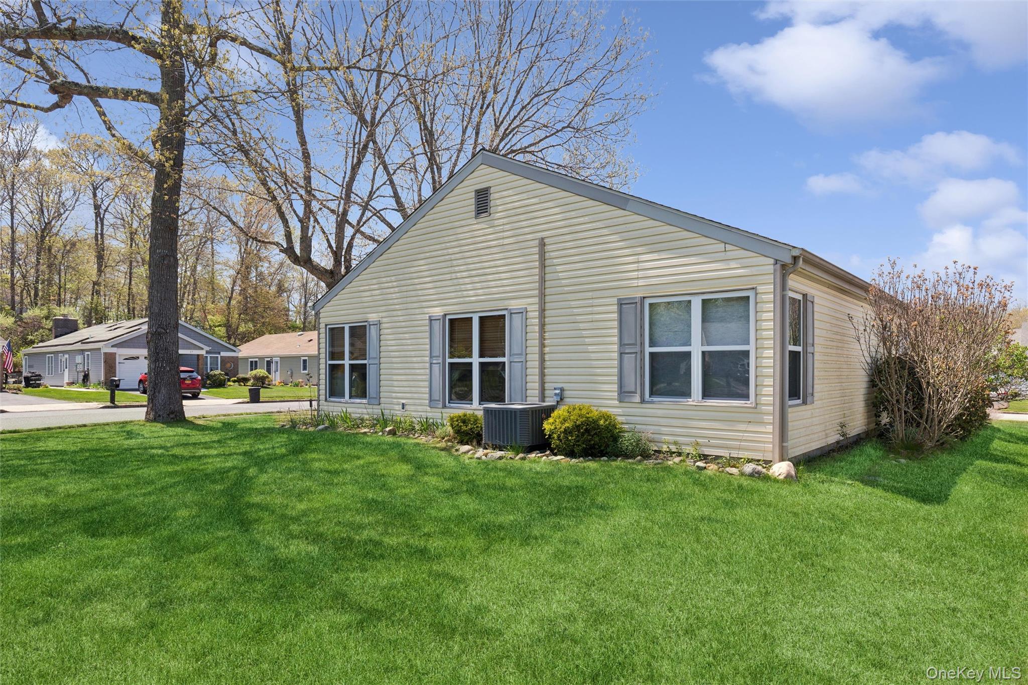 8 Coventry Court Ridge, NY 11961 - Photo 18 of 21 a view of a house with a yard and sitting area