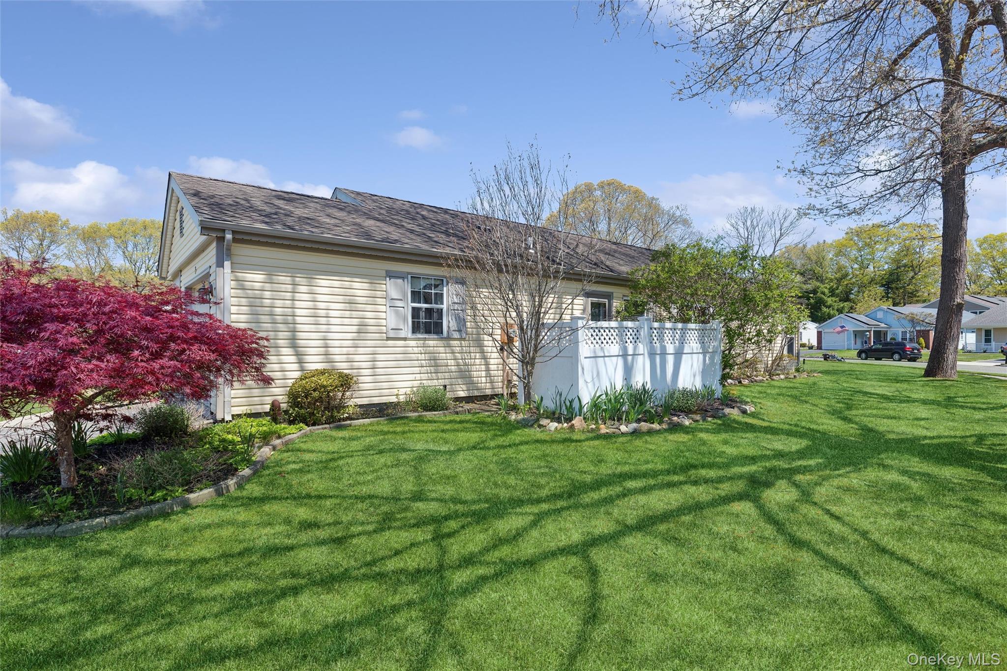 8 Coventry Court Ridge, NY 11961 - Photo 20 of 21 a front view of a house with a garden