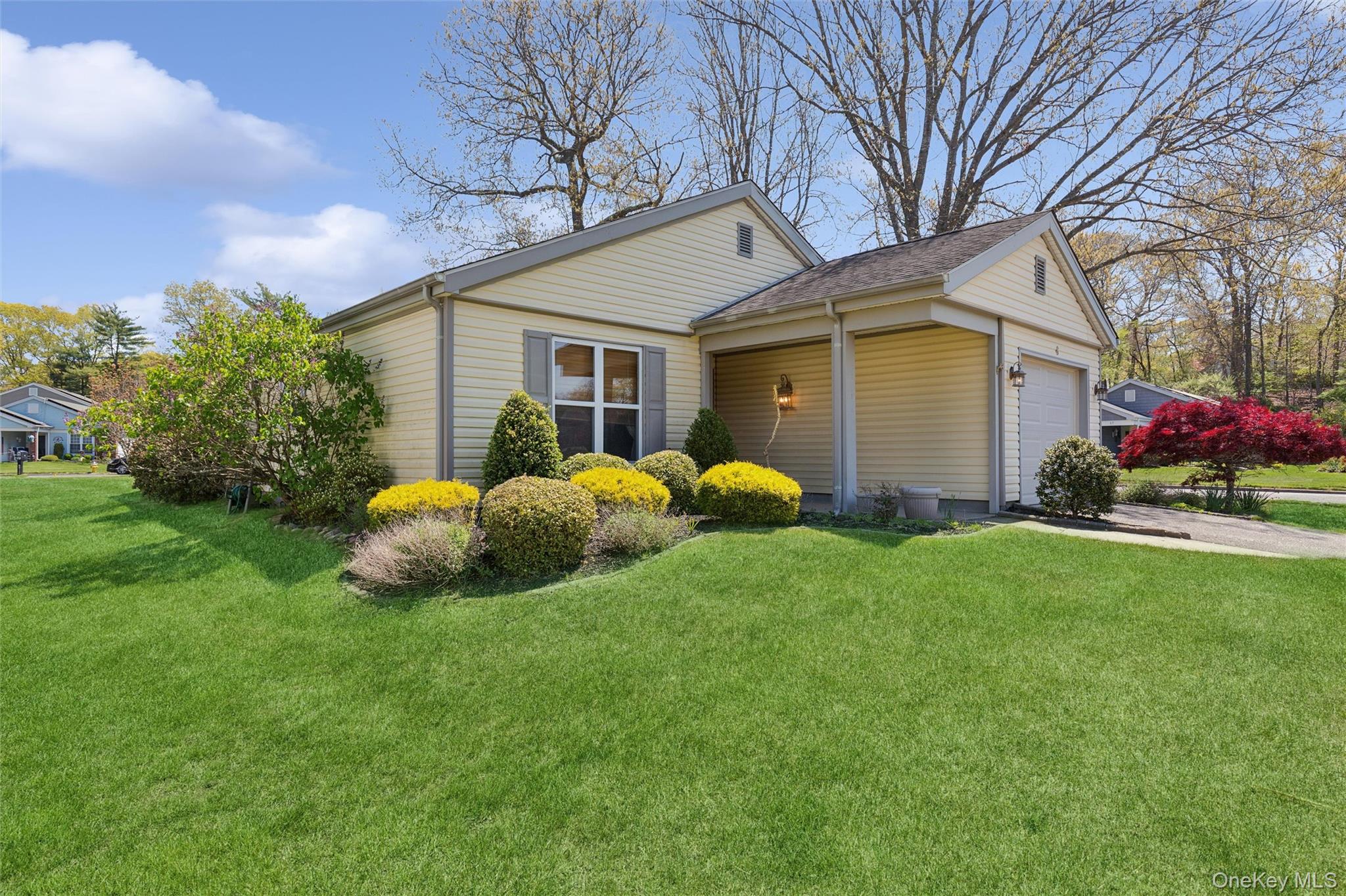 8 Coventry Court Ridge, NY 11961 - Photo 2 of 21 a view of a house with a yard and tree