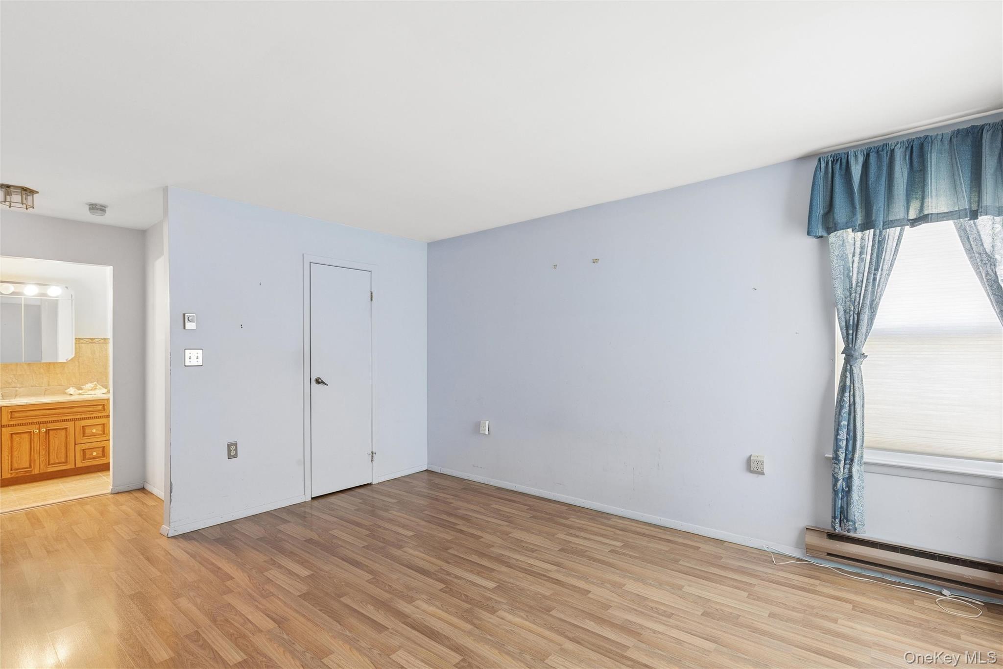 8 Coventry Court Ridge, NY 11961 - Photo 8 of 21 wooden floor in an empty room with a window