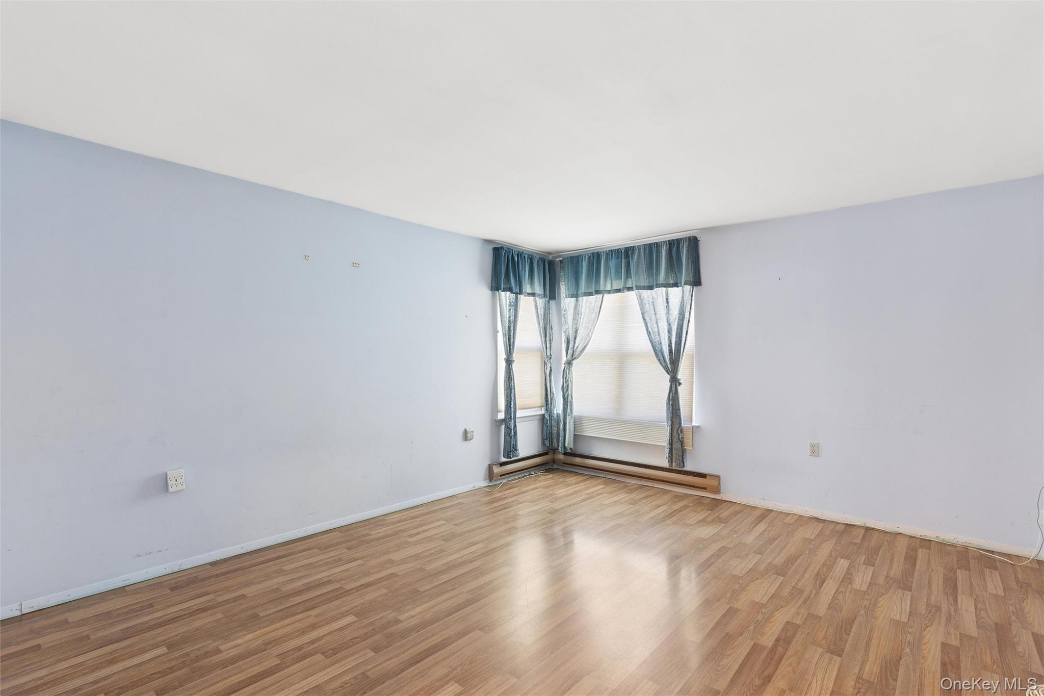8 Coventry Court Ridge, NY 11961 - Photo 9 of 21 an empty room with wooden floor and windows