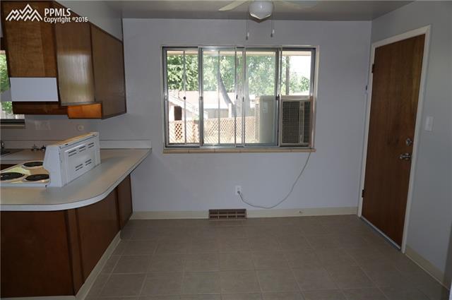 6 North Chelton Road Colorado Springs, CO 80909 - Photo 4 of 30 Dining room with evaporative cooler window unit