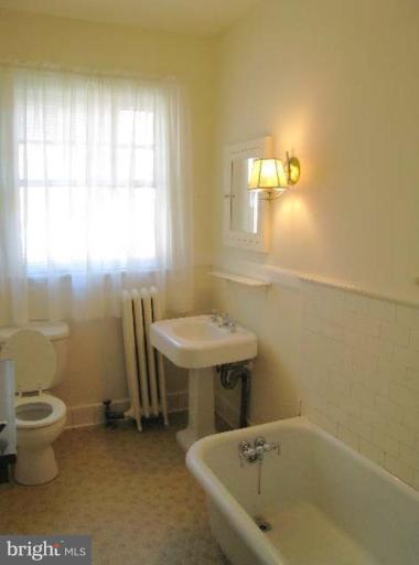 3926 Cloverhill Road Baltimore, MD 21218 - Photo 12 of 24 a bathroom with a sink and a toilet