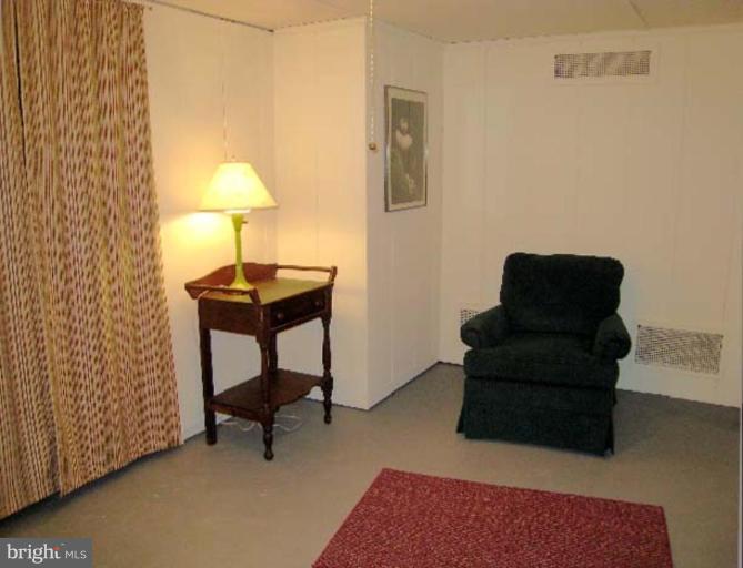 3926 Cloverhill Road Baltimore, MD 21218 - Photo 17 of 24 a view of a workspace with furniture and a lamp