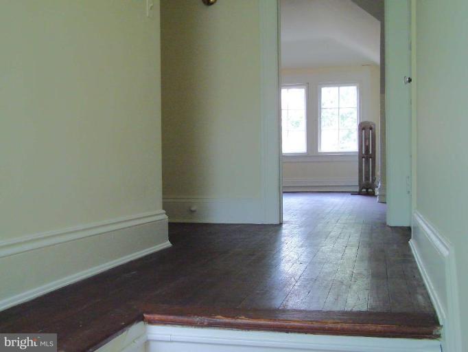 3926 Cloverhill Road Baltimore, MD 21218 - Photo 5 of 24 a view of a hallway with wooden floor