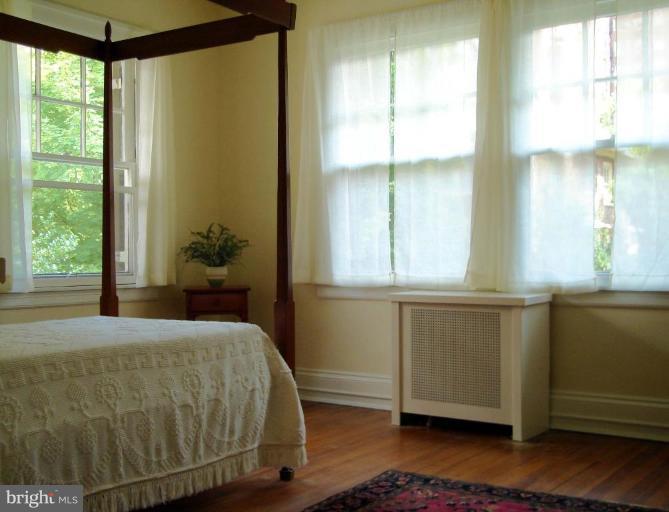3926 Cloverhill Road Baltimore, MD 21218 - Photo 6 of 24 a bedroom with a bed and windows