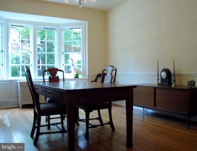 3926 Cloverhill Road Baltimore, MD 21218 - Photo 10 of 24 a dining room with furniture and wooden floor