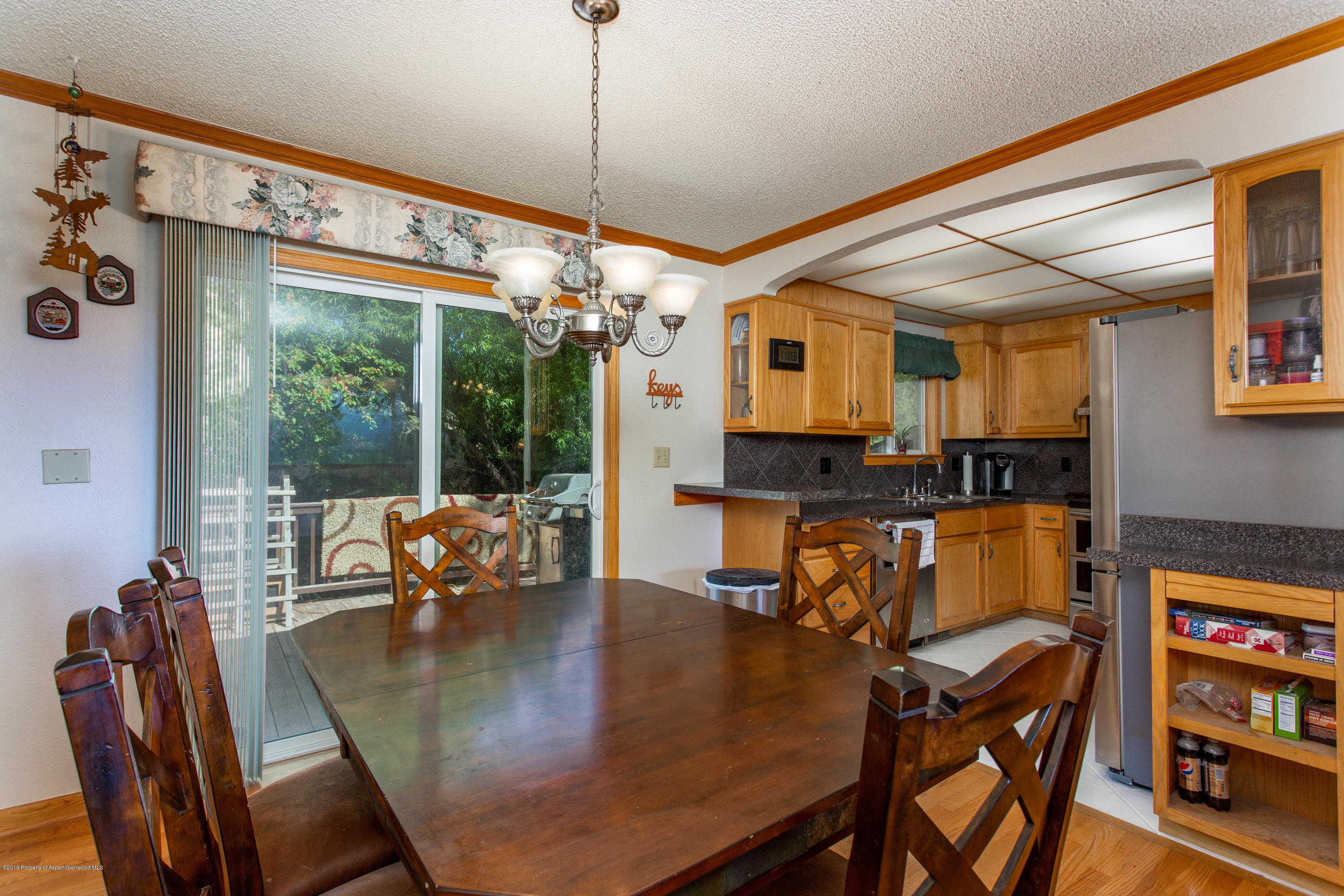535 County Road 260 Rifle, CO 81650 - Photo 11 of 18 a dining room with furniture a chandelier and wooden floor