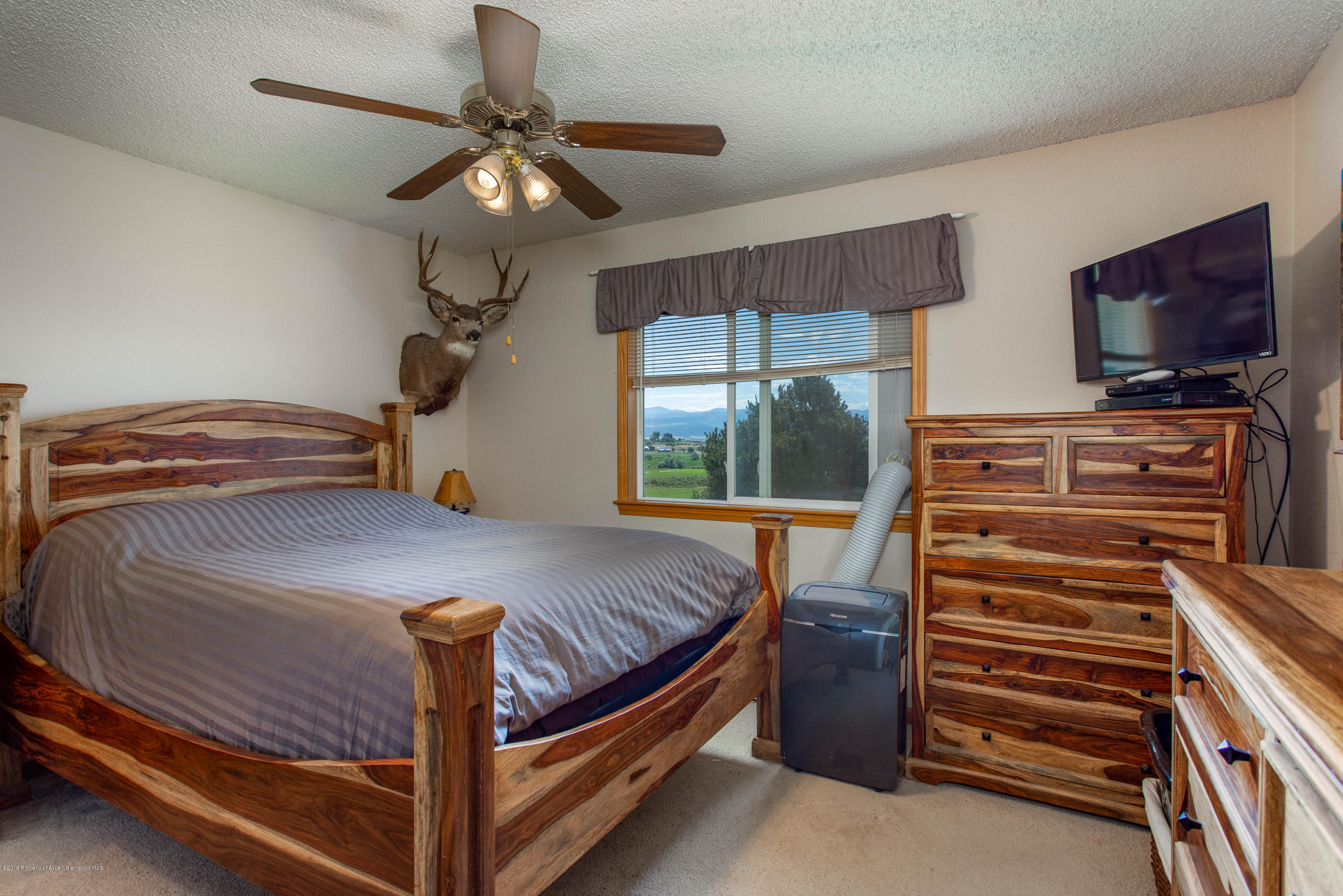 535 County Road 260 Rifle, CO 81650 - Photo 12 of 18 a bedroom with a bed and a flat screen tv
