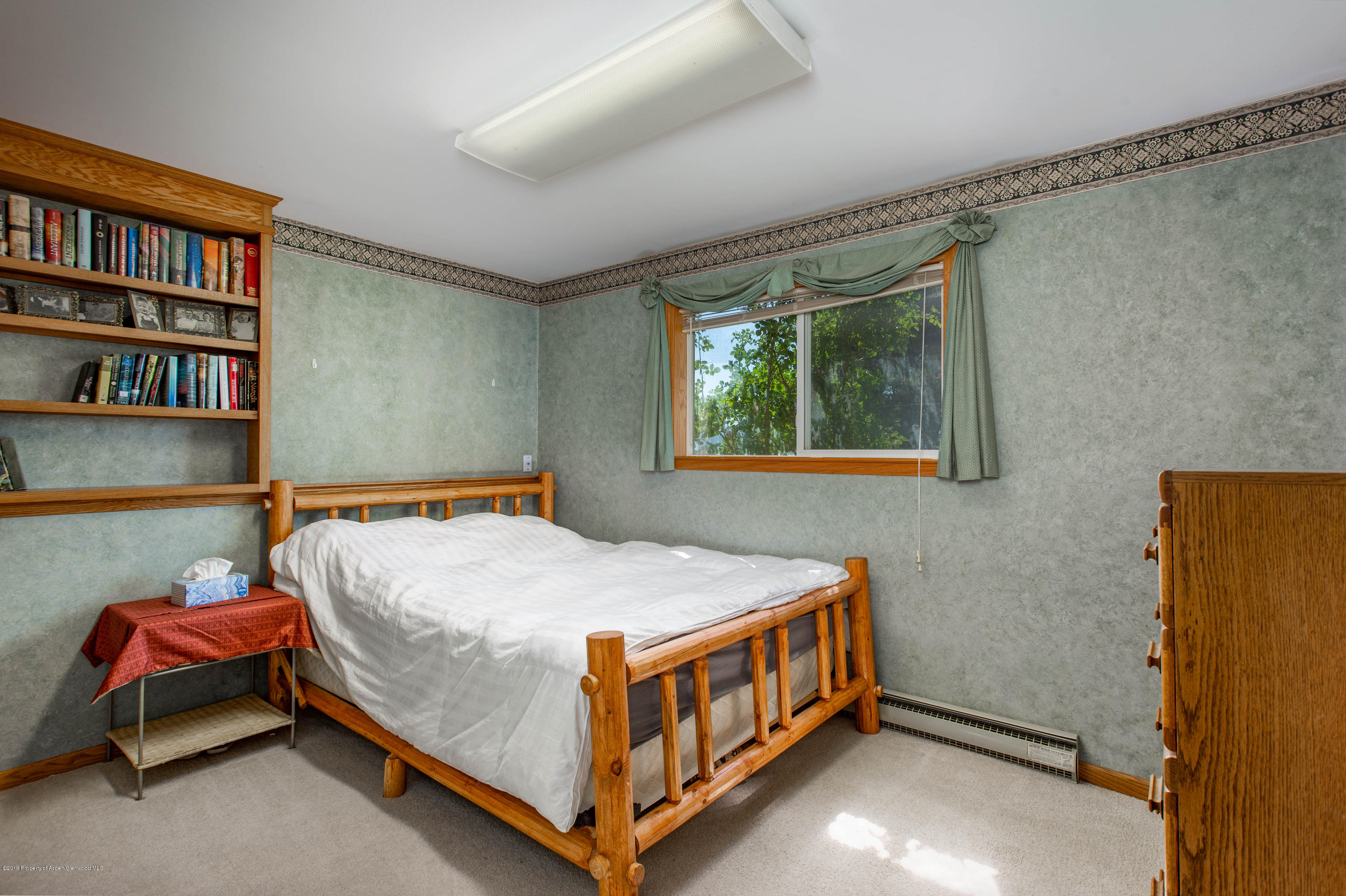 535 County Road 260 Rifle, CO 81650 - Photo 18 of 18 a bedroom with a bed and a book shelf