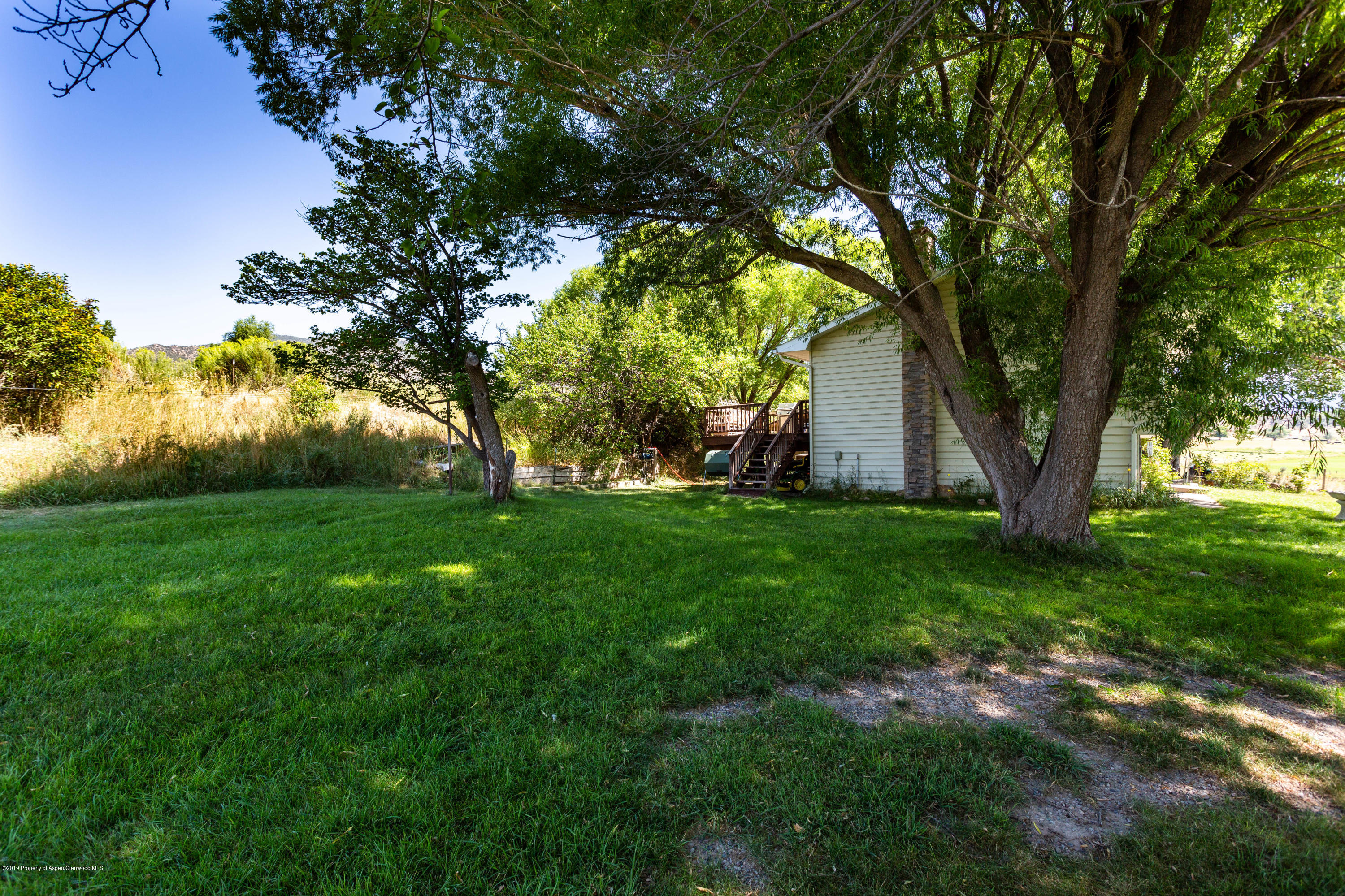 535 County Road 260 Rifle, CO 81650 - Photo 4 of 18 a view of a backyard with large trees
