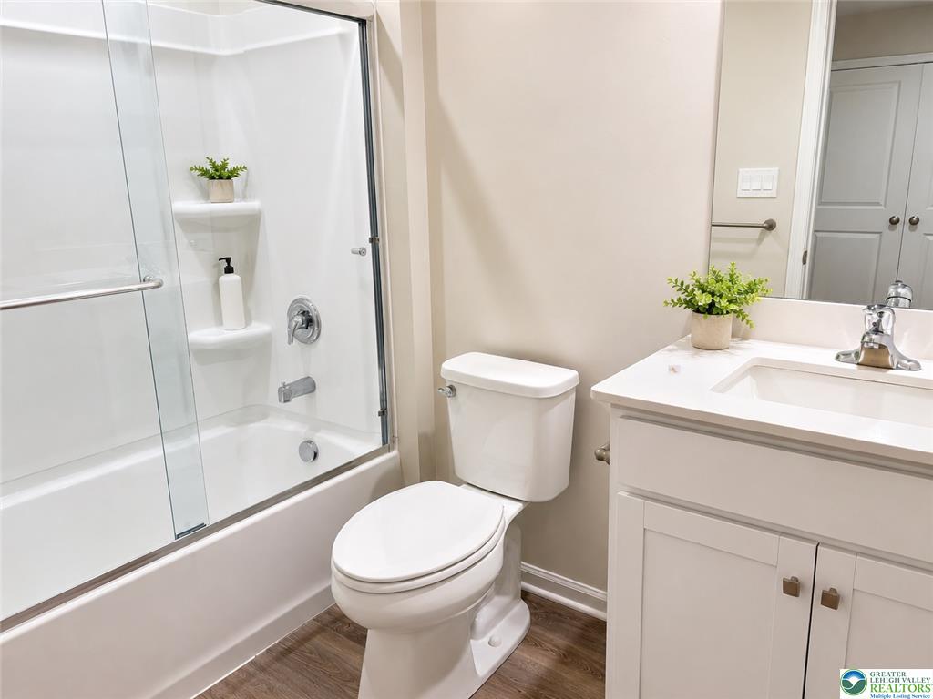 1257 Martin Road Breinigsville, PA 18031 - Photo 12 of 14 A contemporary vanity and tub surround highlight this clean bathroom with durable wood-look flooring.