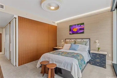 a bedroom with a bed and a painting on the wall