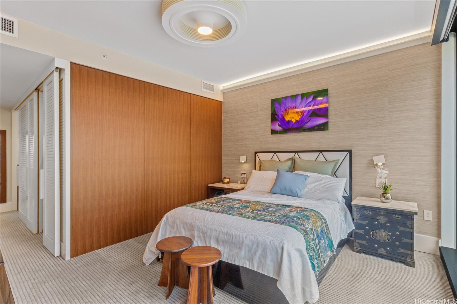 1108 Auahi Street, Unit 307 Honolulu, HI 96814 - Photo 12 of 23 a bedroom with a bed and a painting on the wall