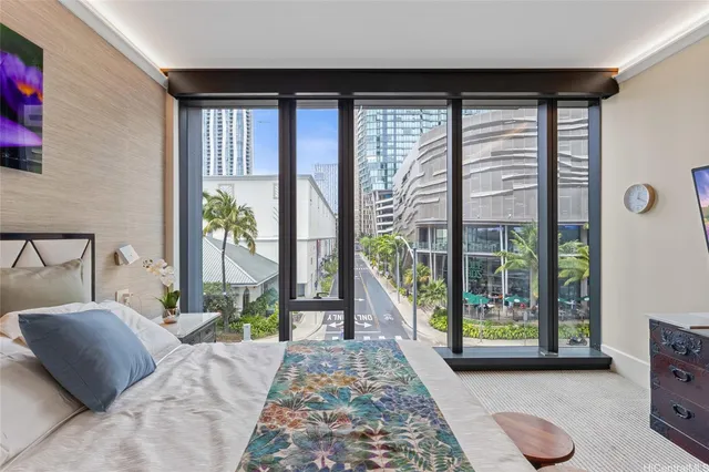 a bedroom with a bed and large windows