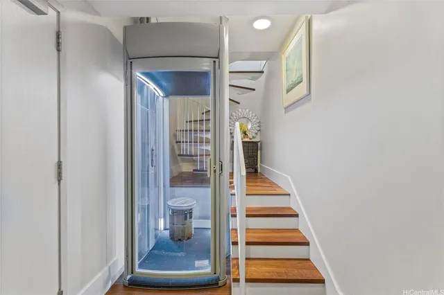 a view of entryway and hall with wooden floor