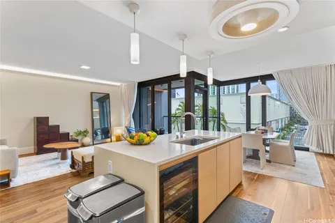 a very nice looking living room with dining room and large windows